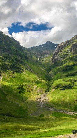 Glencoe scotland landscape with green mountains and stream